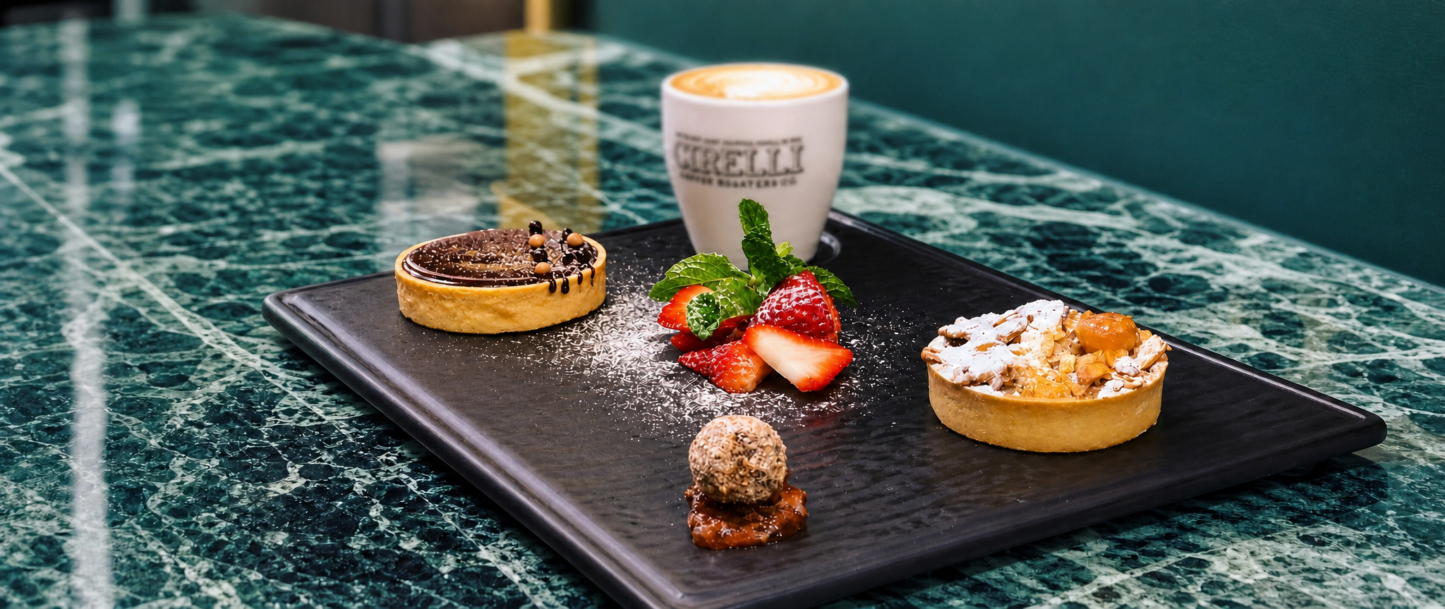 Cirelli Coffee Sweets and Coffee on a black board and green marble table