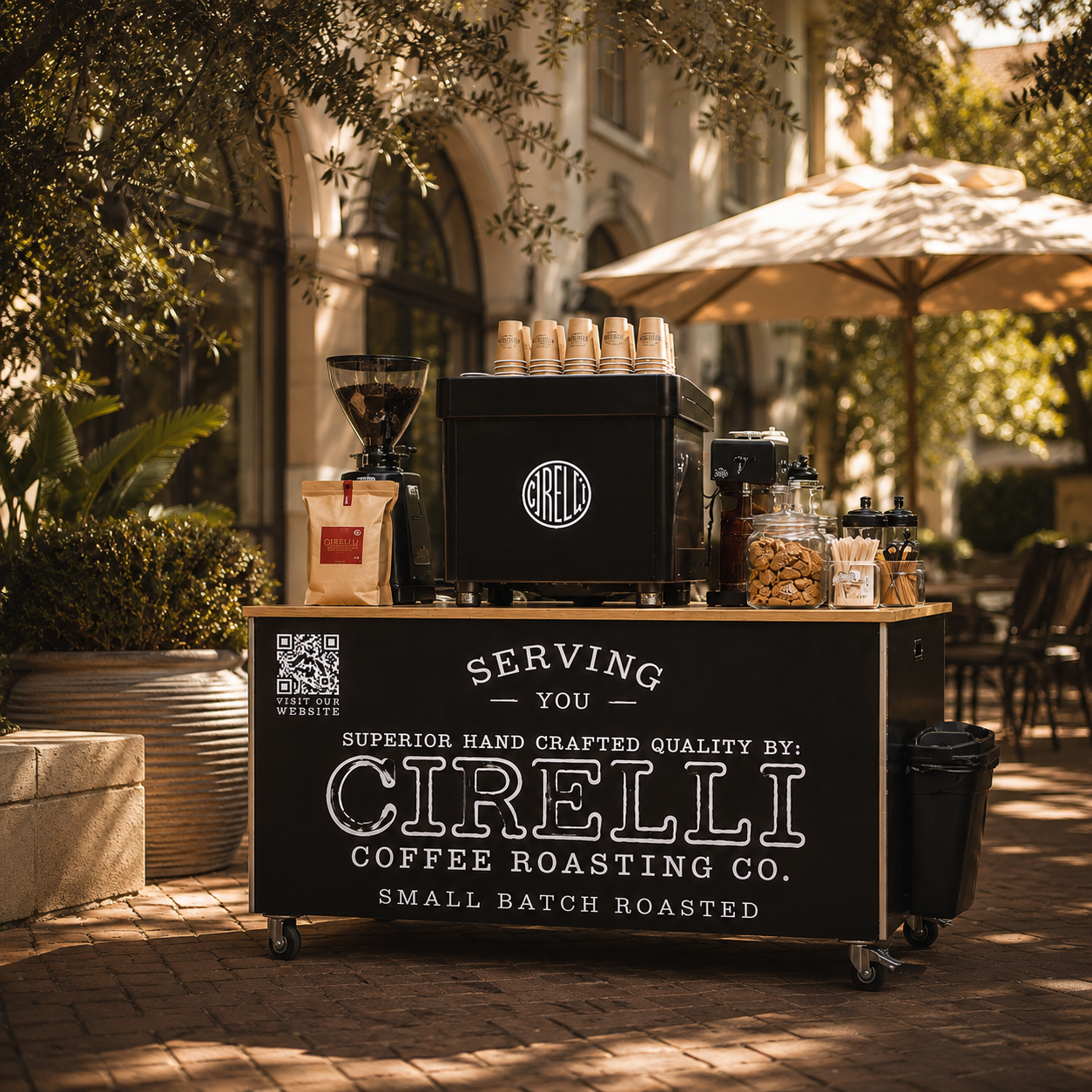 A branded coffee cart at an outdoor patio, with visible Cirelli Coffee Roasting Co. signage on the front and a black roasting machine and cup holders on top.