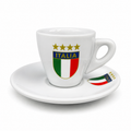 A white ceramic espresso cup and matching saucer set, both printed with the Italy national team crest featuring four gold stars, the word 'ITALIA' on a blue band, and the green, white, and red vertical tricolor shield.