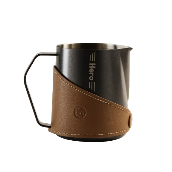 Coffee pitcher with brown leather sleeve on a white background