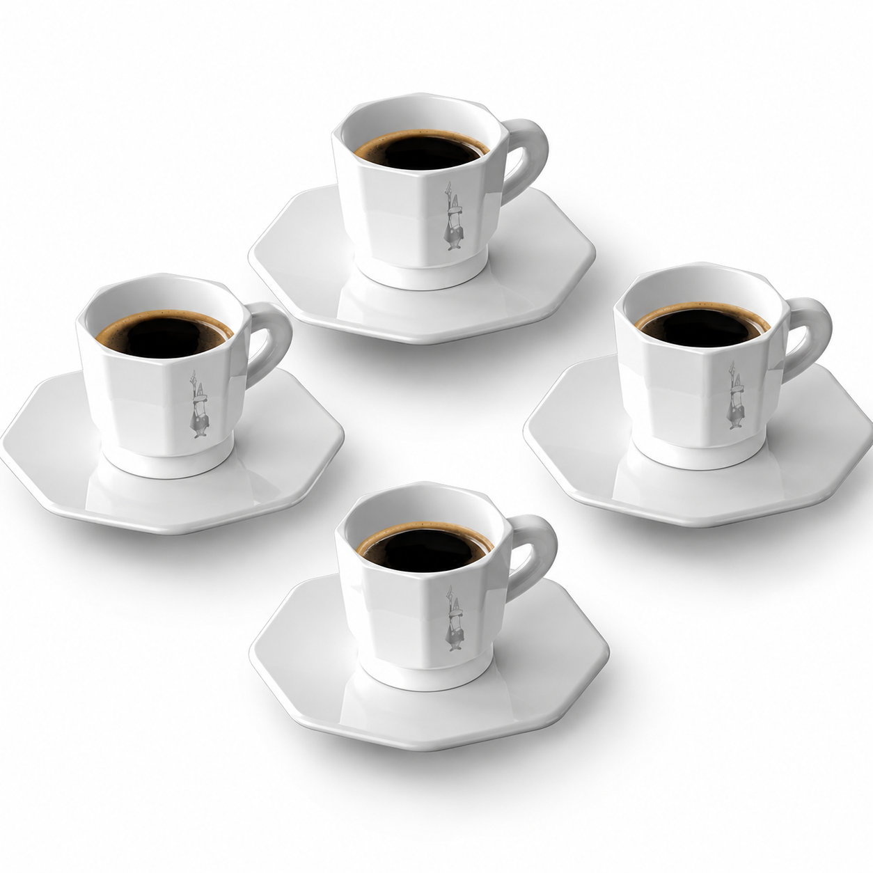 Four white ceramic espresso cups with matching octagonal saucers, each filled with black coffee, arranged on a clean white background.