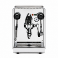 A professional espresso machine with a polished stainless steel body, featuring a central portafilter holder, two black steam wands, a pressure gauge, and a drip tray, shown against a plain white background.