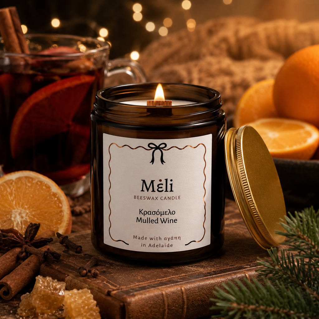 Meli Mulled Wine Beeswax Candle 180g from Cirelli Coffee, a South Australian beeswax candle in a vintage amber glass jar with gold lid, woodwick, 30-hour burn time, Brazilian orange essential oil, and warm fruit, honey, cinnamon, vanilla and spice fragrance notes.