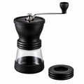 Hario Ceramic Coffee Mill Skerton Pro from Cirelli Coffee, a manual ceramic burr coffee grinder with improved grind adjustment, anti-slip grip, transparent lid, detachable stainless steel handle and glass bowl hopper for fresh home coffee brewing.