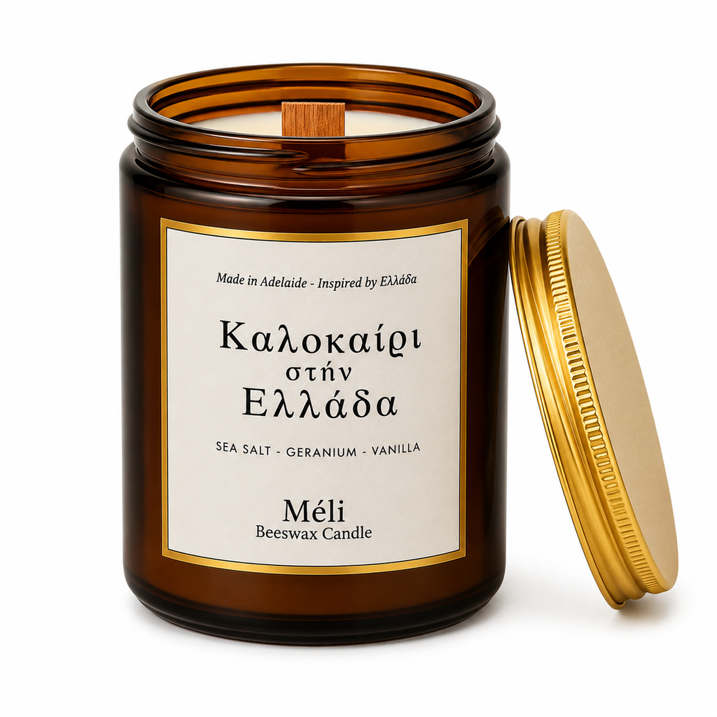 Meli Kalokeri Stin Ellada Summer in Greece Beeswax Candle 180g from Cirelli Coffee, a South Australian beeswax candle in a gloss amber jar with gold lid, wood wick, 35-hour burn time, and fresh sea salt, geranium and vanilla fragrance notes.