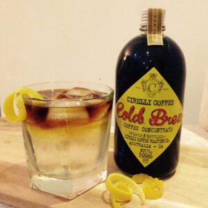 500ml cold brew bottle alongside a icyglass of gin and tonic